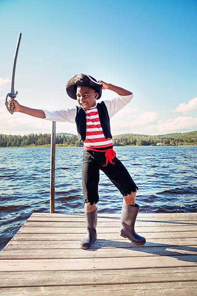 istock African-american child dressed as pirate on a lake. 179165009