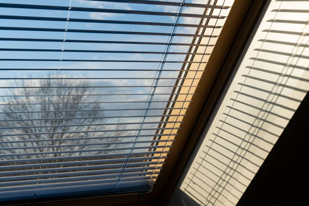 istock Half lowered window blinds in front of the blue sky 1791650342