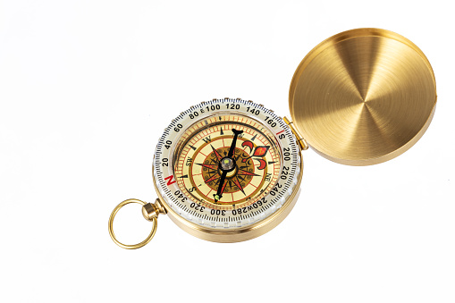 Compass old vintage brass nautical compass isolated on white background