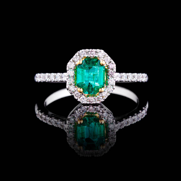 istock beautiful white gold ring with diamonds and emerald on a black background 1791667904