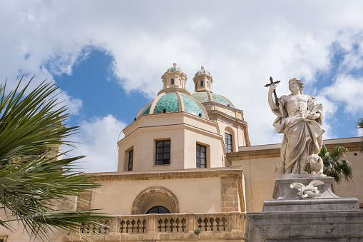The 11th century cathedral of the city of Mazara del Vallo with in front the 18th century statue of St. Vitus, Sicily, Italy