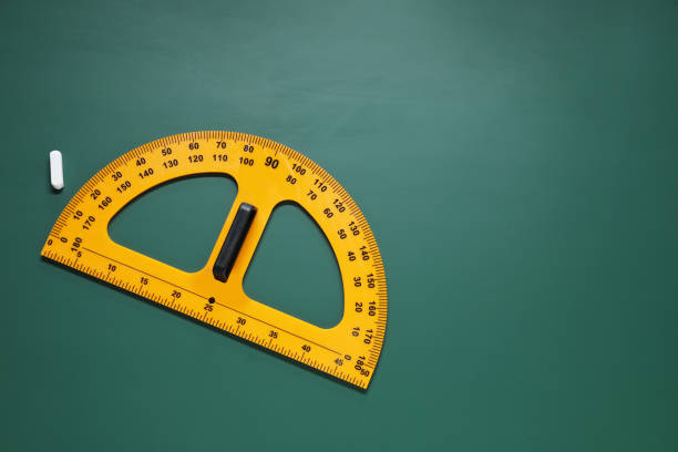 istock Yellow protractor and chalk on green chalkboard, flat lay. Space for text 1791671775