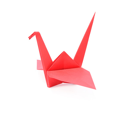 Origami art. Beautiful red paper crane isolated on white