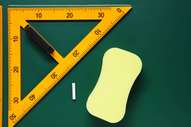 istock Protractor, sponge, chalk and ruler on green chalkboard, flat lay 1791672851