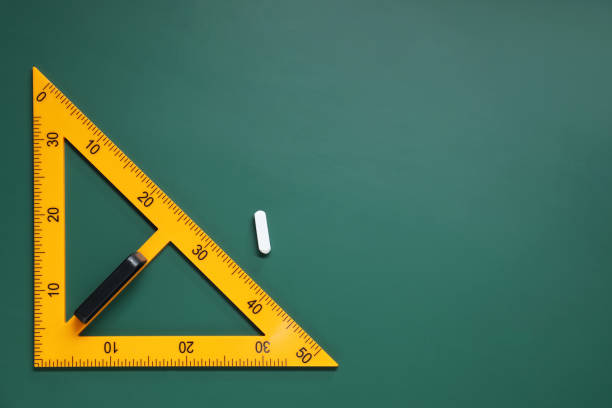 istock Yellow triangle and chalk on green chalkboard, flat lay. Space for text 1791672861