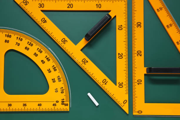 istock Protractor, triangles and chalk on green chalkboard, flat lay 1791672865