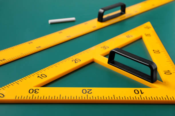 istock Triangle, ruler and chalk on green chalkboard, closeup 1791673029