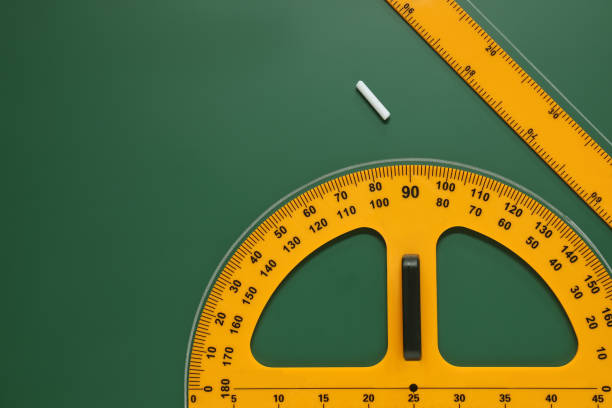 istock Protractor, ruler and chalk on green chalkboard, flat lay. Space for text 1791673444