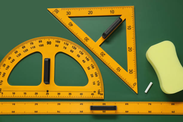 istock Protractor, triangle, ruler and sponge on green chalkboard, flat lay 1791673475