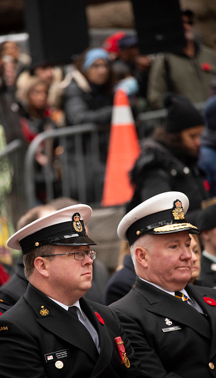 Toronto Ontario, Canada- November 11th, 2023: a photo of the Toronto fire chief Matthew Pegg and anther man during Remembrance Day at Old City Hall in downtown Toronto.