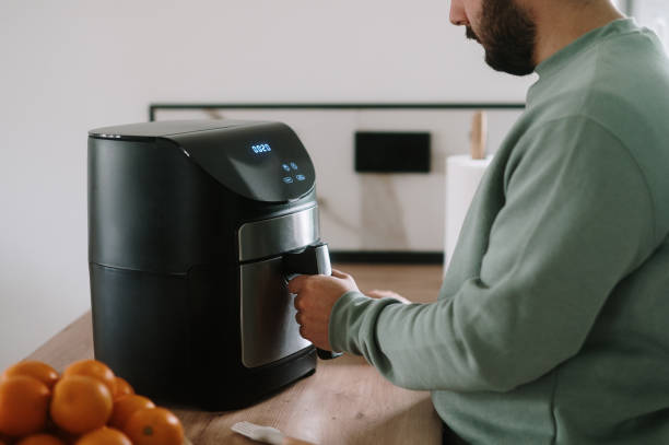 istock Man cooking in an air fryer 1791690527