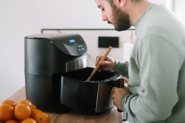 istock Man cooking in an air fryer 1791690552