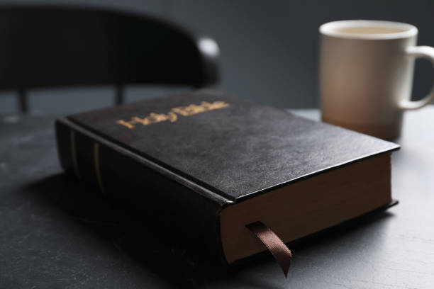 istock Hardcover Bible on black table indoors, closeup. Religious book 1791694417