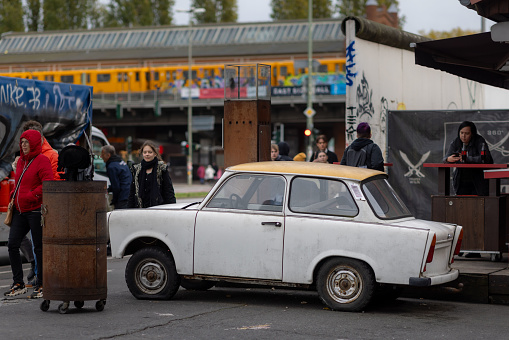 Berlin, Germany - Nov 3rd 2023: Trabant is a legendary car, produced in former East Germany. One is still standing in Berlin as an attraction in front of a restaurant.