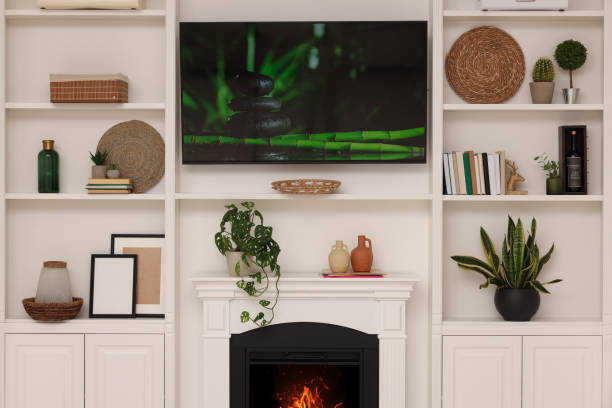 istock TV, fireplace and shelves with different decor in room. Interior design 1791695463