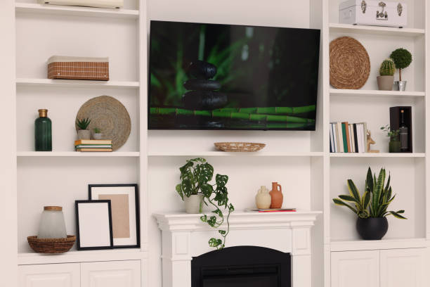 istock TV, fireplace and shelves with different decor in room. Interior design 1791695518