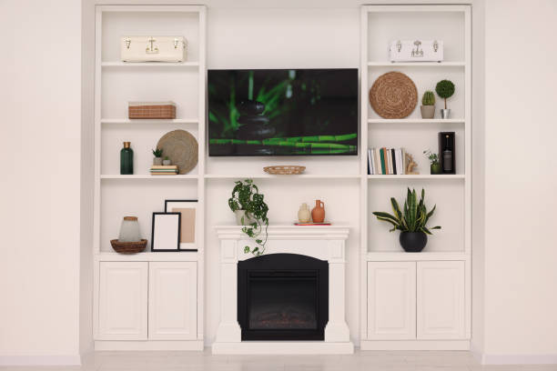 istock TV, fireplace and shelves with different decor in room. Interior design 1791695521