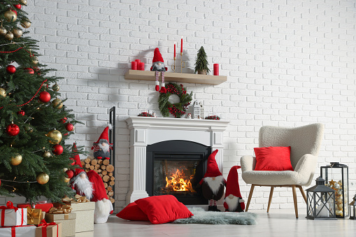 Beautiful Christmas themed photo zone with tree and fireplace in room