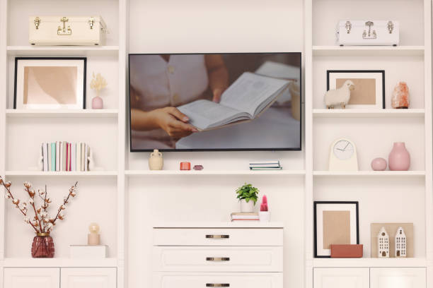 istock TV and shelves with different decor in room. Interior design 1791696056