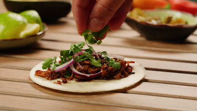 Traditional mexican food tacos with onion and cilantro on the top close-up. Homemade tacos with meat and vegetables