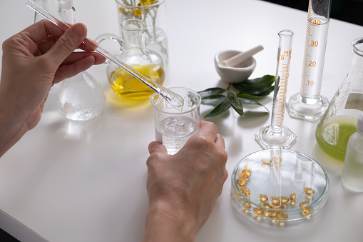 scientist is making cosmetic and skin care in the laboratory with the natural ingredient, such as oil and herbal.