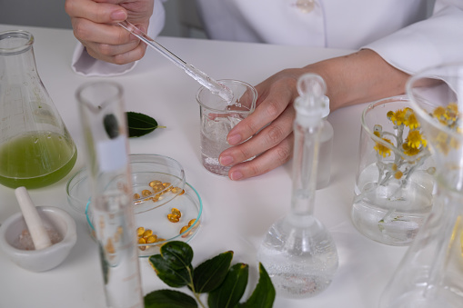 Cosmetic and skincare laboratory. The scientist is making gel for beauty products.