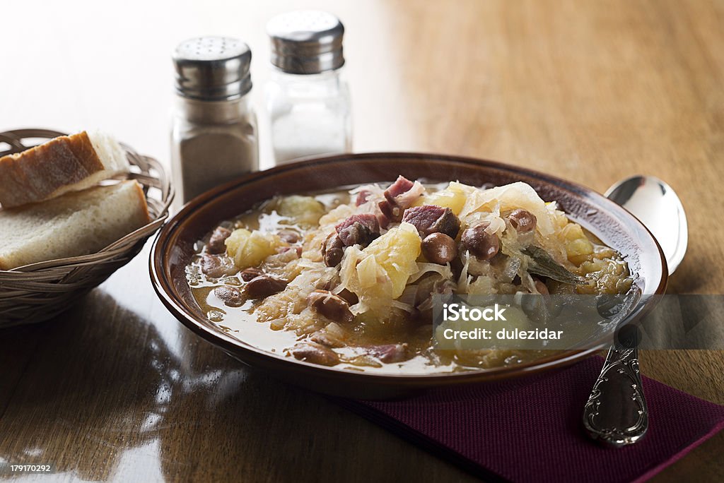 Cabbage stew Fresh cabbage stew with potatoes, meat and beans close up Stew Stock Photo