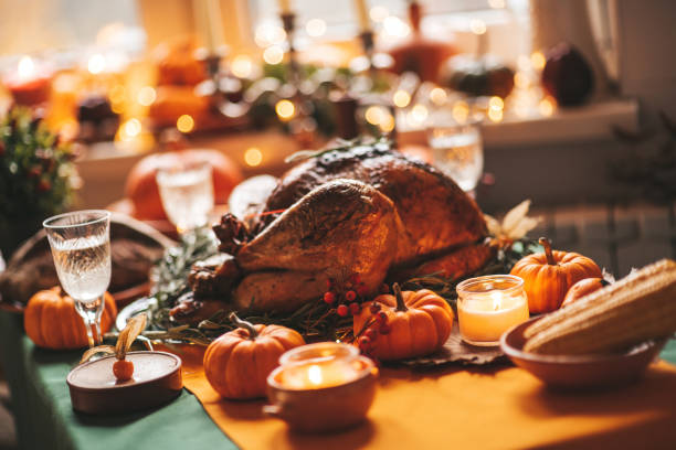 Thanksgiving holiday dinner table setting with fall decoration and pumpkins