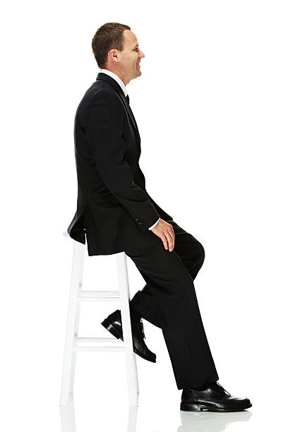 istock Smiling businessman sitting on a stool 179172309