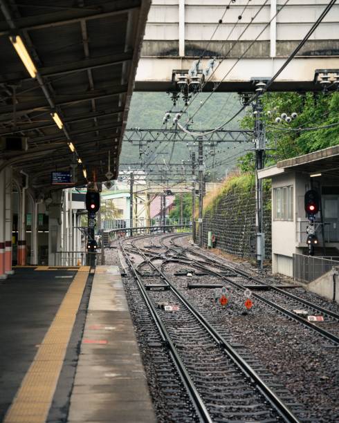 istock a train platform and train on it's track with several people waiting 1791724375