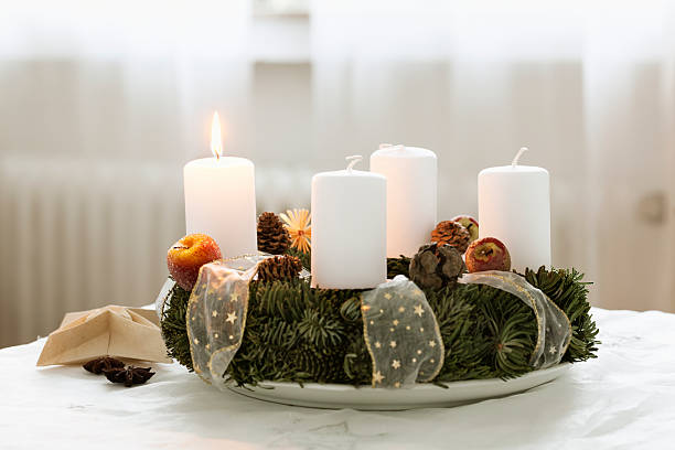 advent wreath burning candle at cristmas time advent wreath on table, one candle burning advent candle wreath adventskranz stock pictures, royalty-free photos & images
