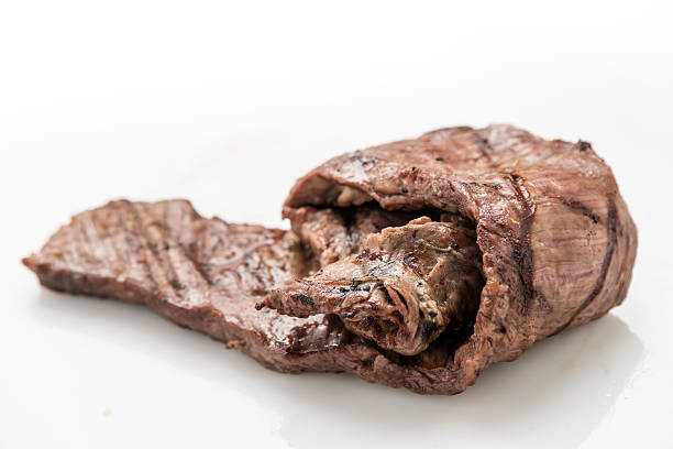 sausages and pork steaks cooked on a large barbaque with hot coals and aromatic herbs