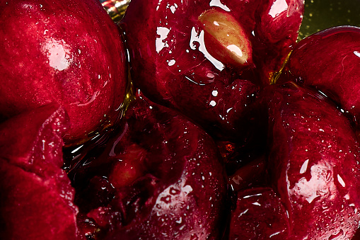 Close up cross-section of cherries covered in honey