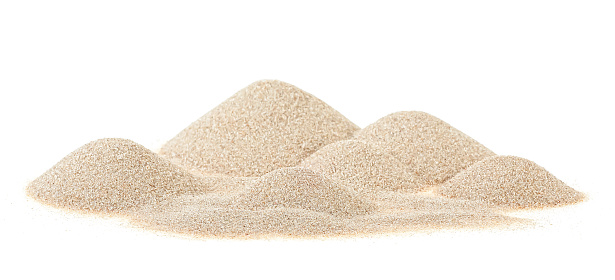 Pile of dry beach sand on white background. Desert sand dunes.