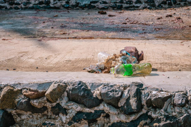 istock Plastic garbage collected from seashore left at concrete sidewalk. Close up photo 1791743299