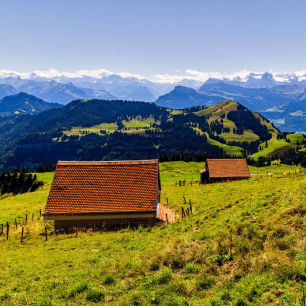 istock some small houses that are in the grass with mountains behind them 1791753791