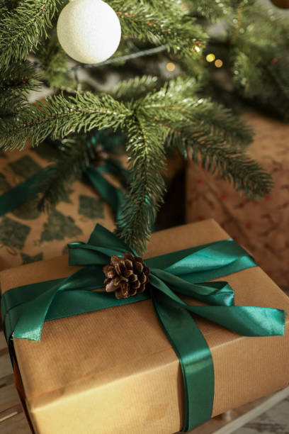 istock Christmas gift with a green bow under the Christmas tree 1791756406