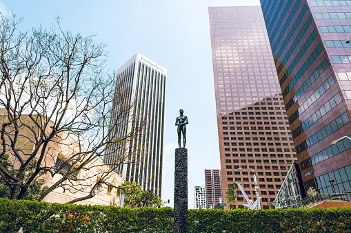 Los Angeles, California, USA - April 25, 2023. Source Figure sculpture by Robert Graham, and los Angeles skyline. Library Tower Plaza on the 5th Street in the Downtown Los Angeles