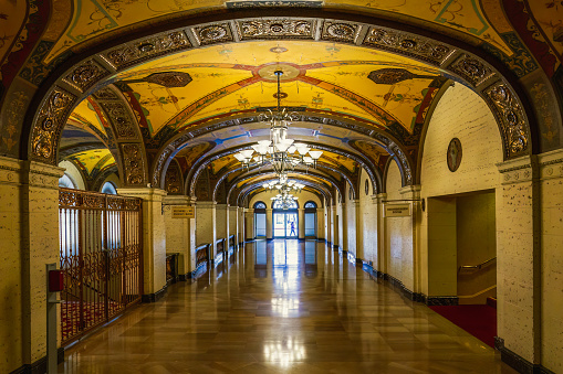 Los Angeles, California, USA - April 25, 2023. Historic Millennium Biltmore Hotel interior. The interior of the hotel is decorated with frescos and murals, massive wood-beamed ceilings, travertine and oak paneled walls