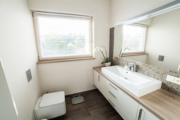Banheiro brilhante com pia e vaso sanitário - foto de acervo