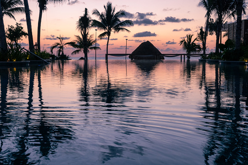 The sun rises over the Gulf of Mexico and is reflected in the infinity pool at the resort