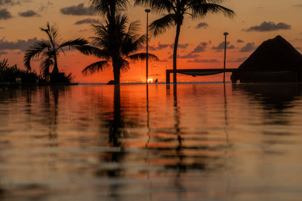 The sun rises over the Gulf of Mexico and is reflected in the infinity pool at the resort