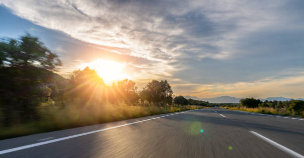 istock Empty long road on a sunny summer day at bright sunset 1791800625