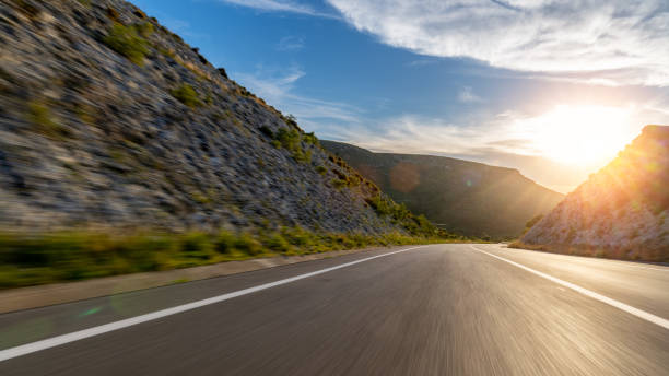 istock Empty long road on a sunny summer day at bright sunset 1791800626