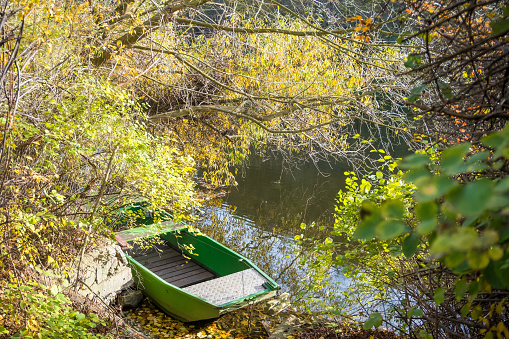 Beautiful views of the river Berounka and Wooden boats in the autumn season, forest and mountains, Hlasna Treban. Czech republic. High quality photo