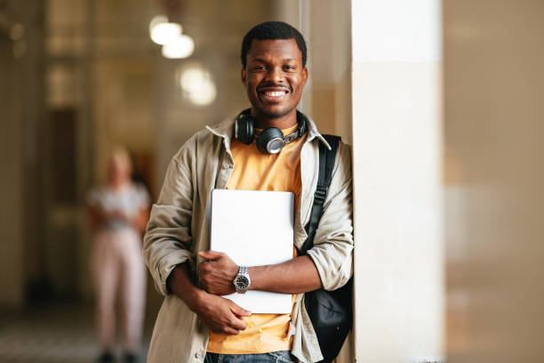 istock A Happy Handsome Young Man With Headphones Looking At Camera While Being At School 1791810724