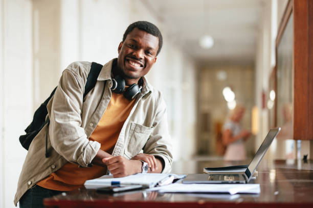 istock A Happy Handsome Student Looking At Camera While Standing In The College Corridor 1791810729