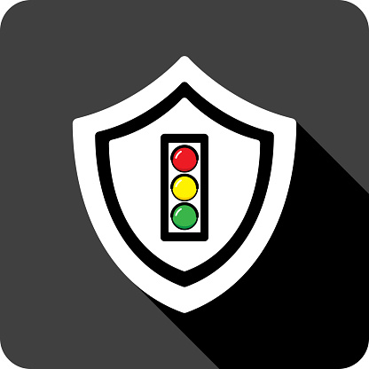 Vector illustration of a shield with traffic light icon against a black background in flat style.
