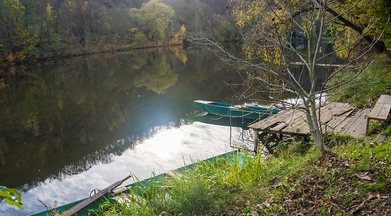 Beautiful views of the river Berounka and Wooden boats in the autumn season, forest and mountains, Hlasna Treban. Czech republic. High quality photo