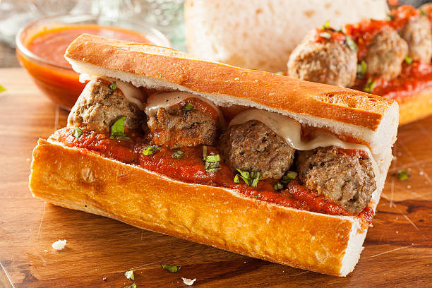 Hot and Homemade Spicy Meatball Sub Sandwich Homemade Spicy Meatball Sub Sandwich with Marinara Sauce and Cheese submarine photos stock pictures, royalty-free photos & images